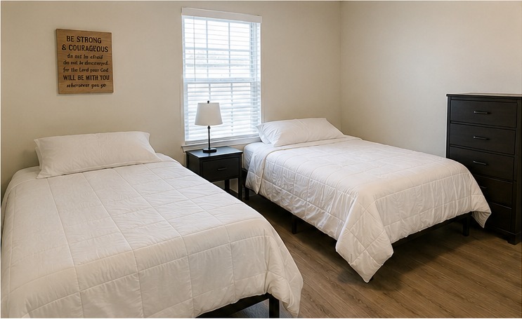 Standard shared bedroom with two full-size beds and plain white bedding